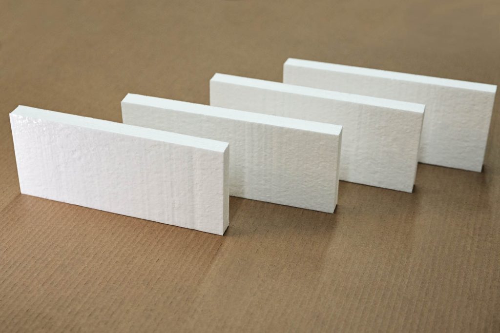 Four pieces of foam, stood up and staggered one behind the other.